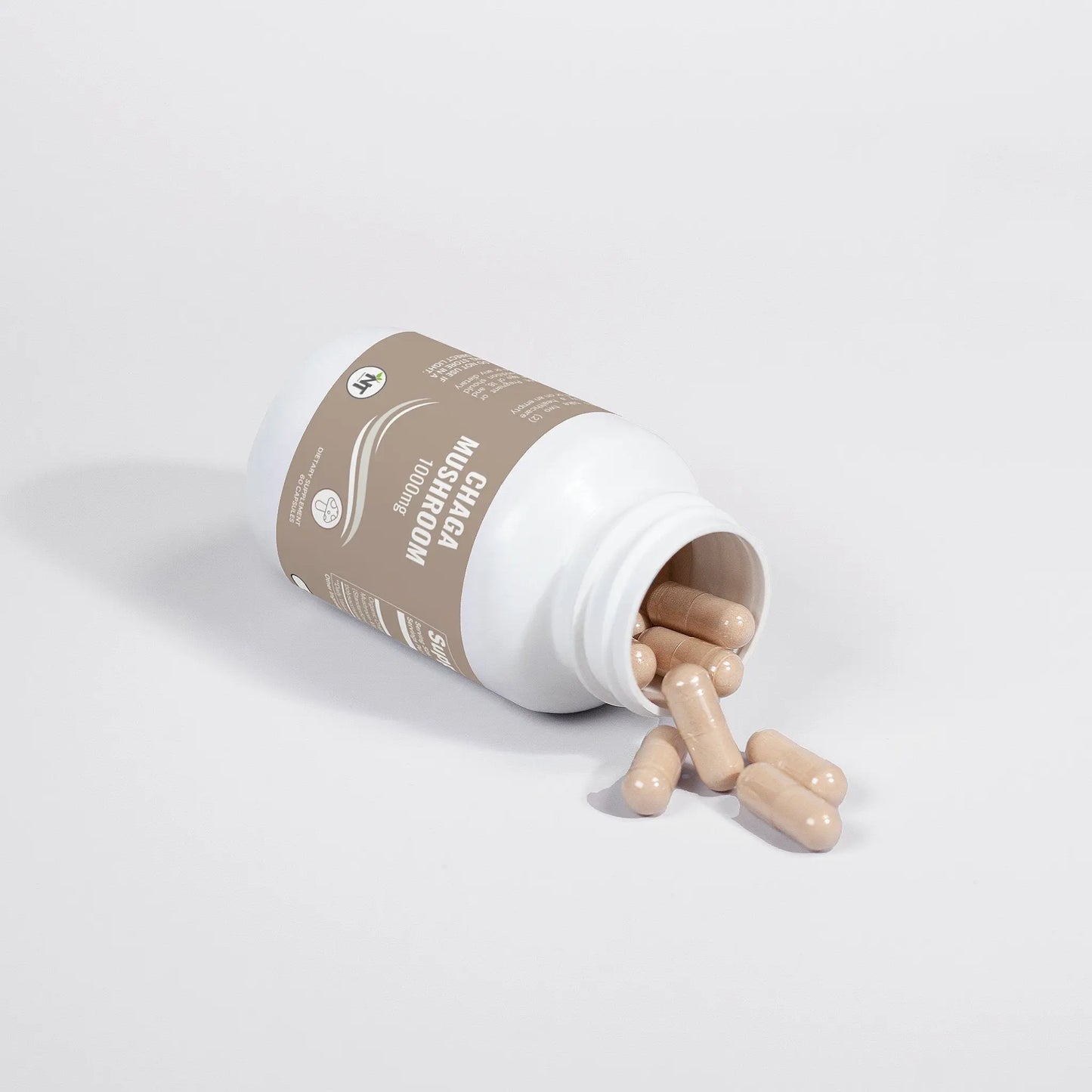 Chaga Mushroom Capsules bottle tipped over with capsules spilling out – Nutrition Tribune