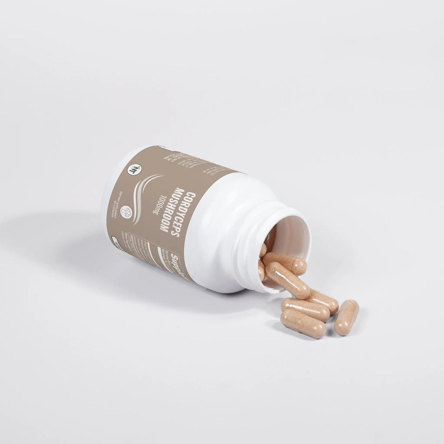 Cordyceps Mushroom Capsules bottle tipped over with vegan capsules spilling onto white surface