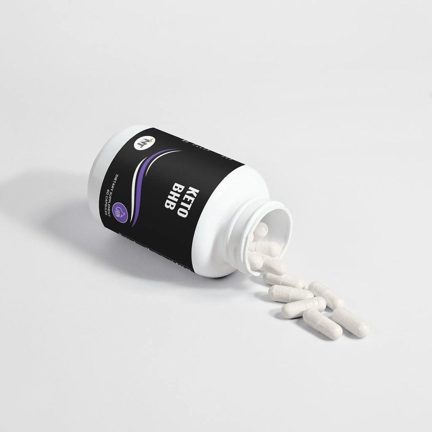 Keto BHB supplement bottle tipped over with capsules spilling out on white background