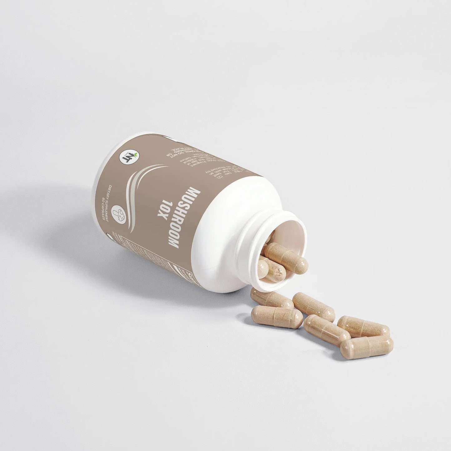 Mushroom Complex 10X Capsules spilling from an open bottle on white background.