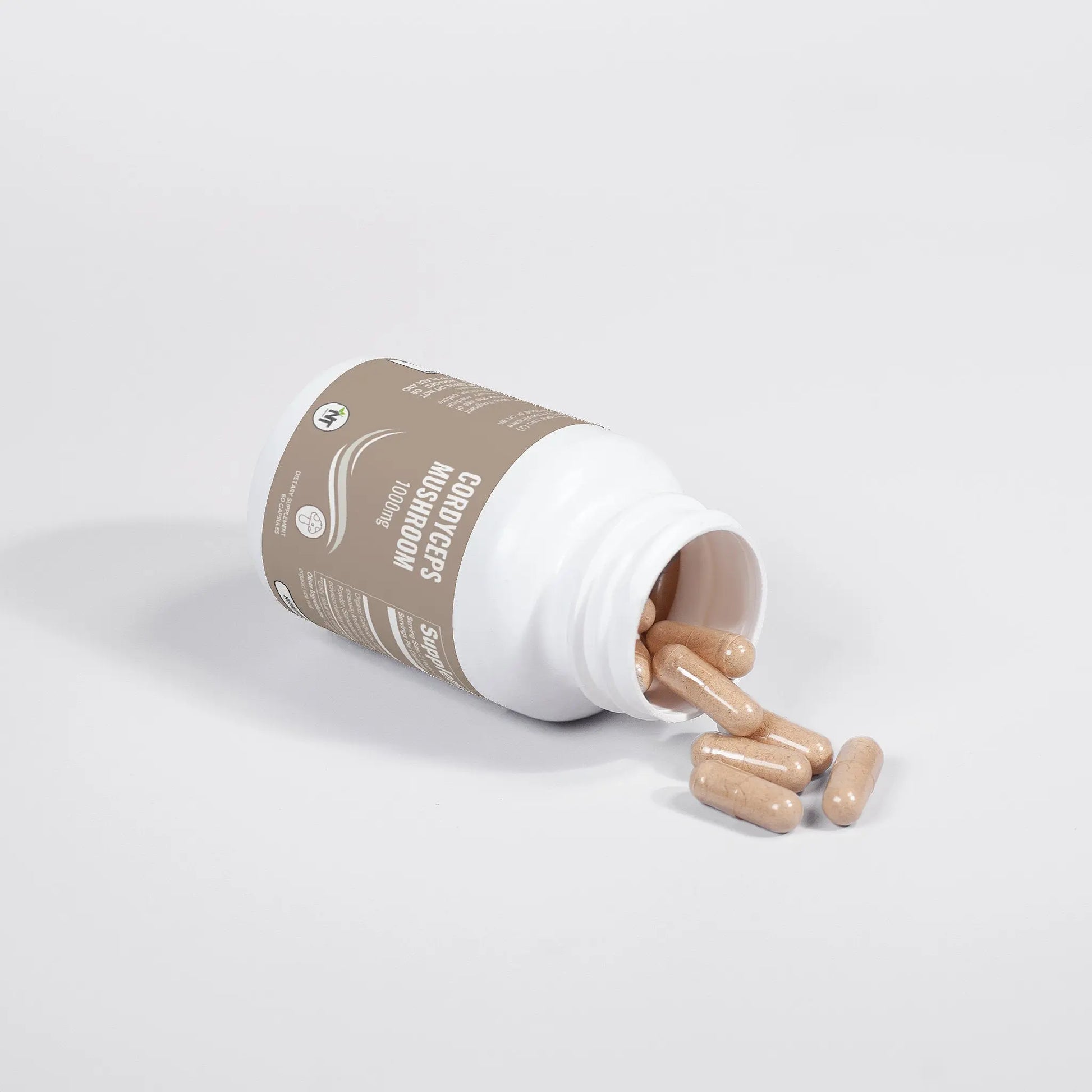 Cordyceps Mushroom Capsules bottle tipped over with vegan capsules spilling onto white surface