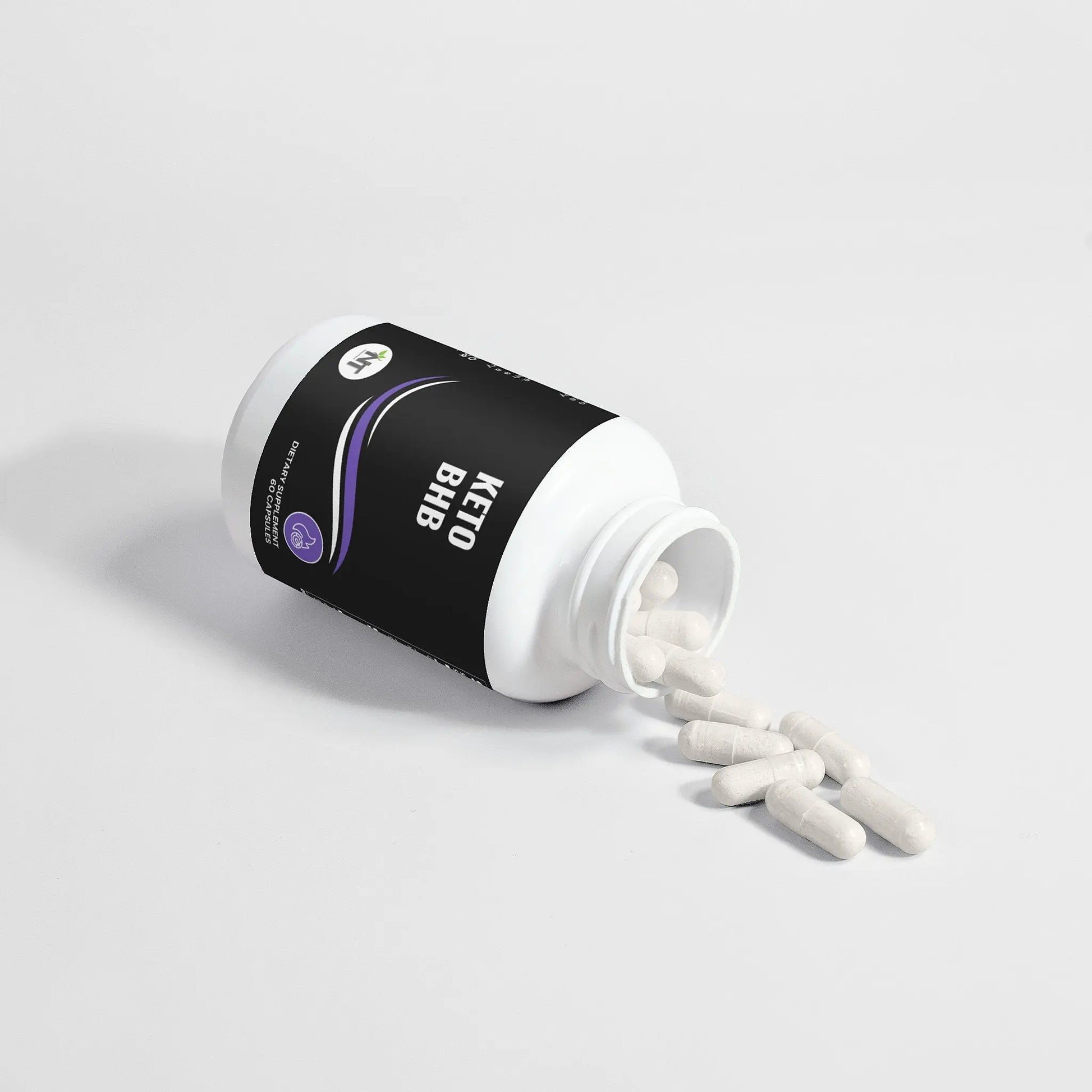 Keto BHB supplement bottle tipped over with capsules spilling out on white background
